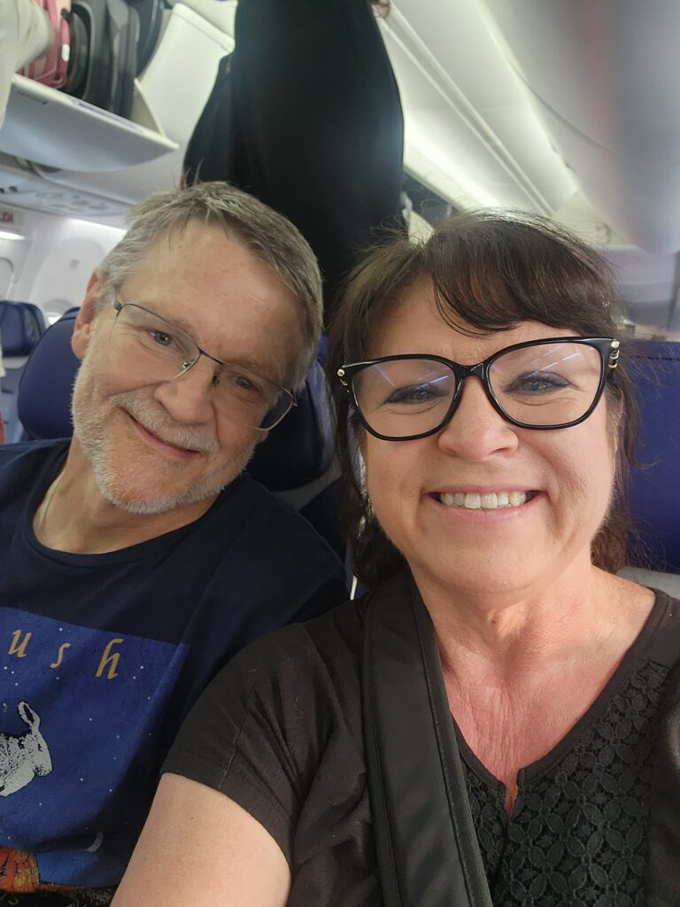 Couple on a plane heading out for adventure