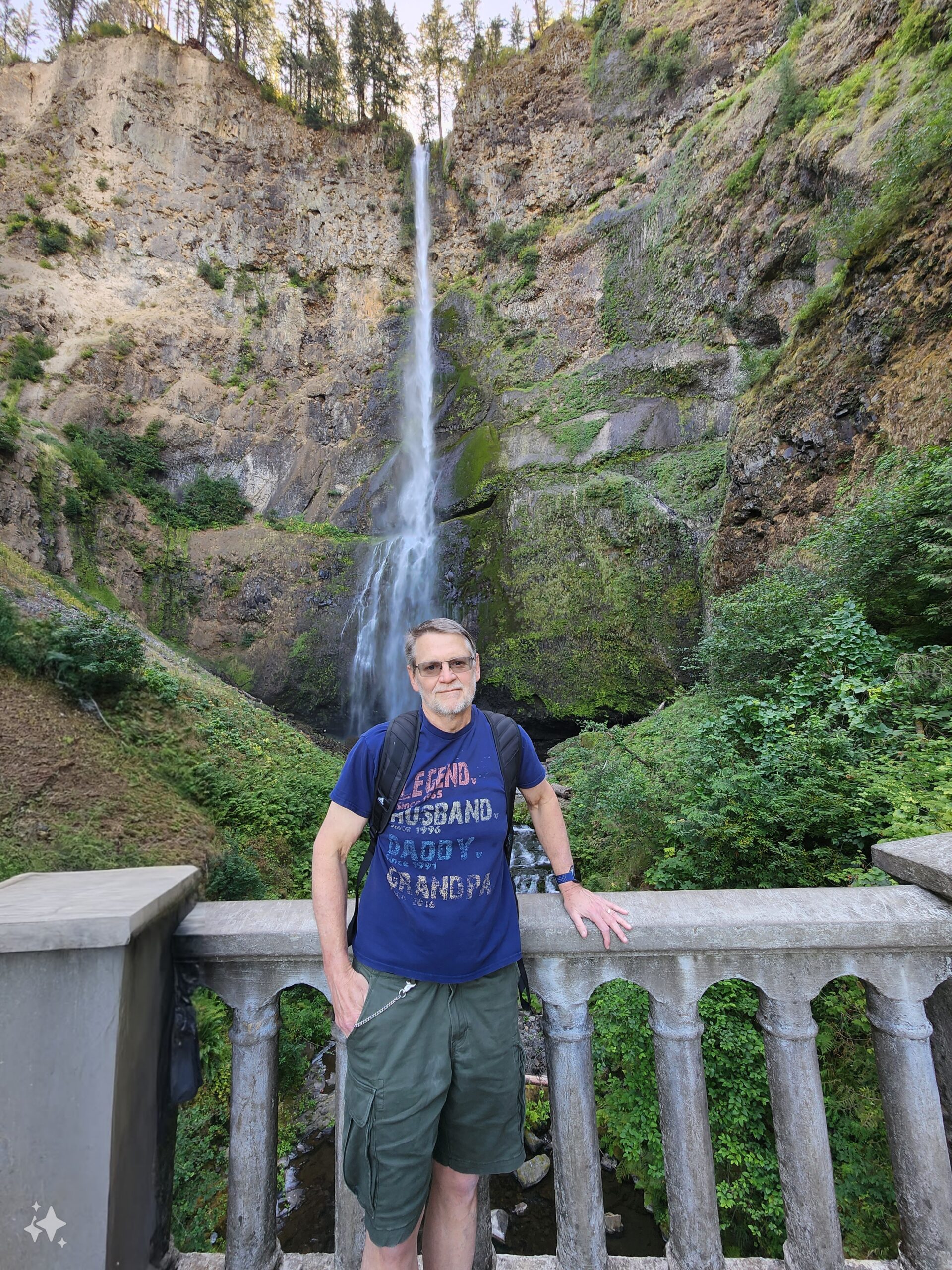 Tom in front of a waterfall on a hike