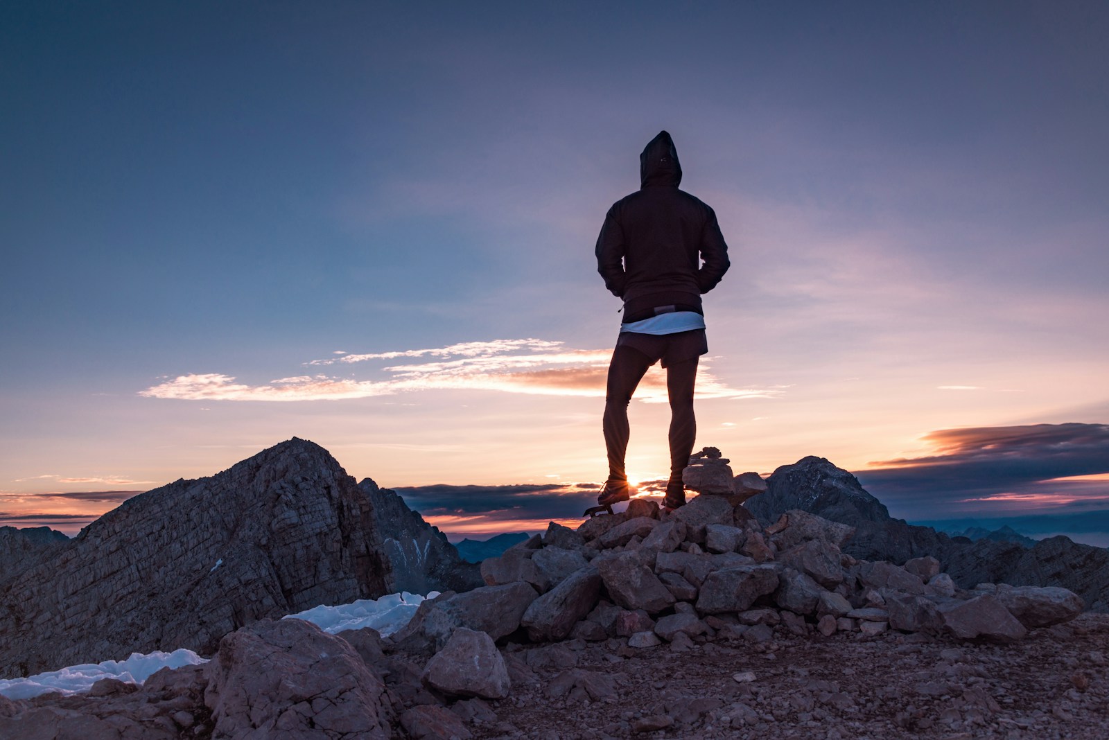 A person standing on a mountain trail at sunrise, symbolizing personal growth and new beginnings.