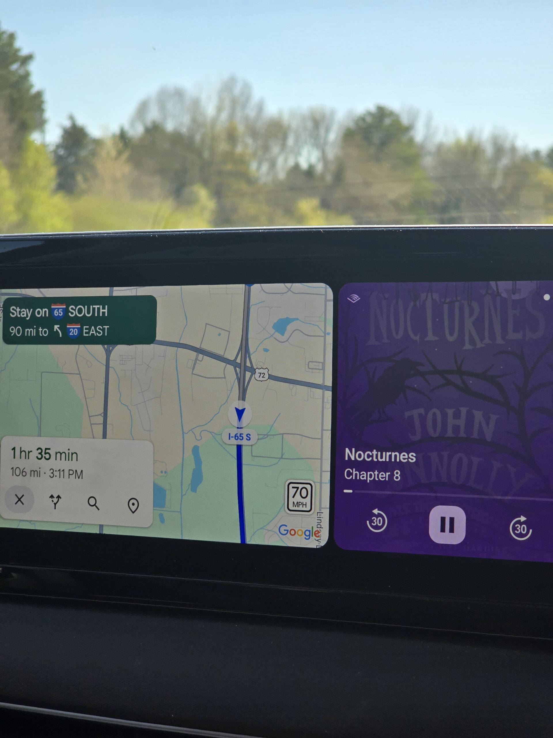 Planning the family road trip route with a map and listening to Audible – mindful road trip experience