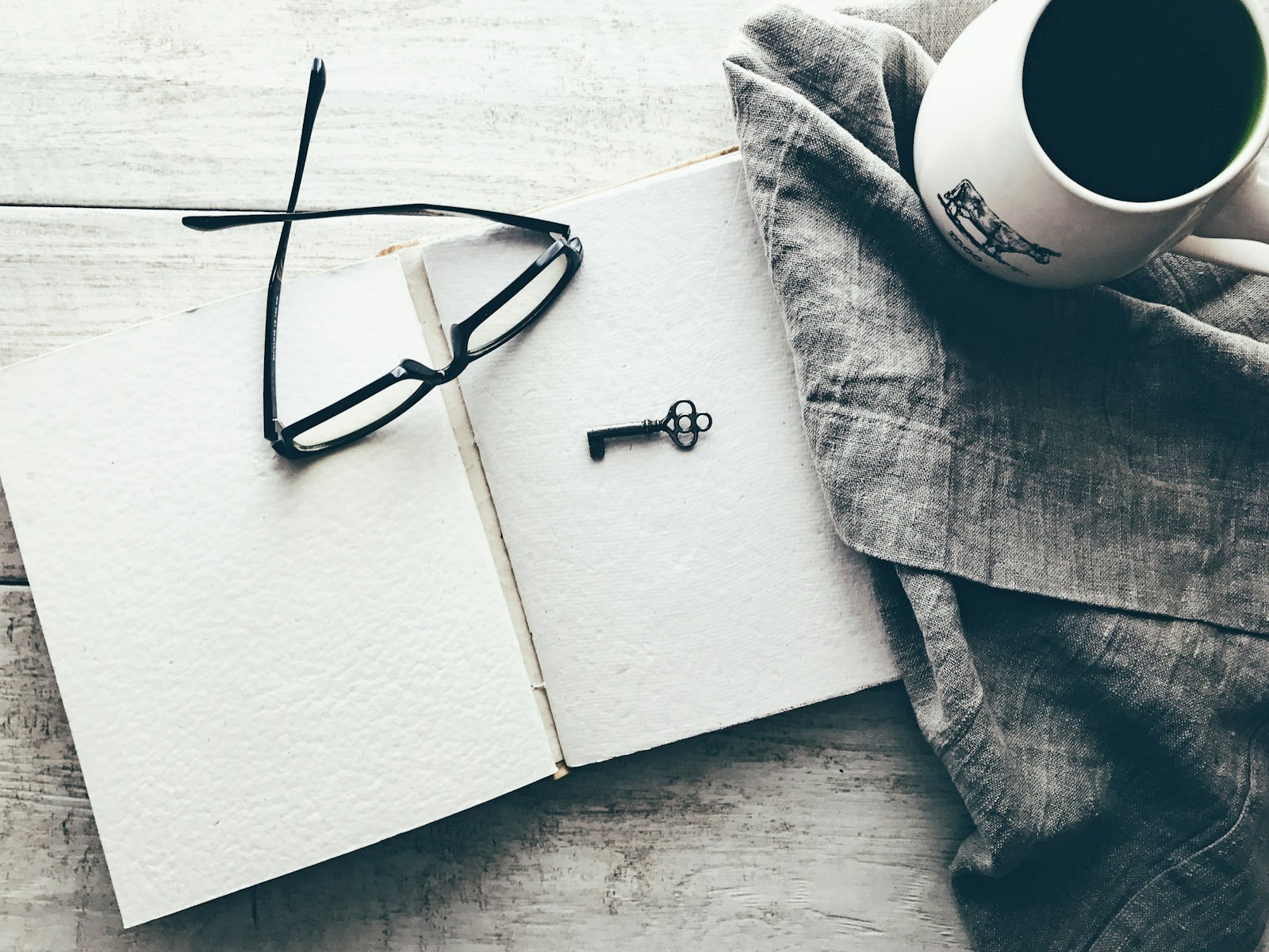 Woman journaling in a cozy setting with a cup of tea, promoting intentional relaxation and mental recovery.