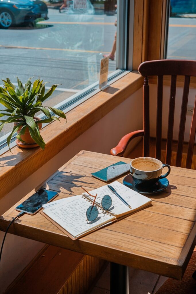 Finding everyday adventure by visiting a new coffee shop and journaling about new experiences.