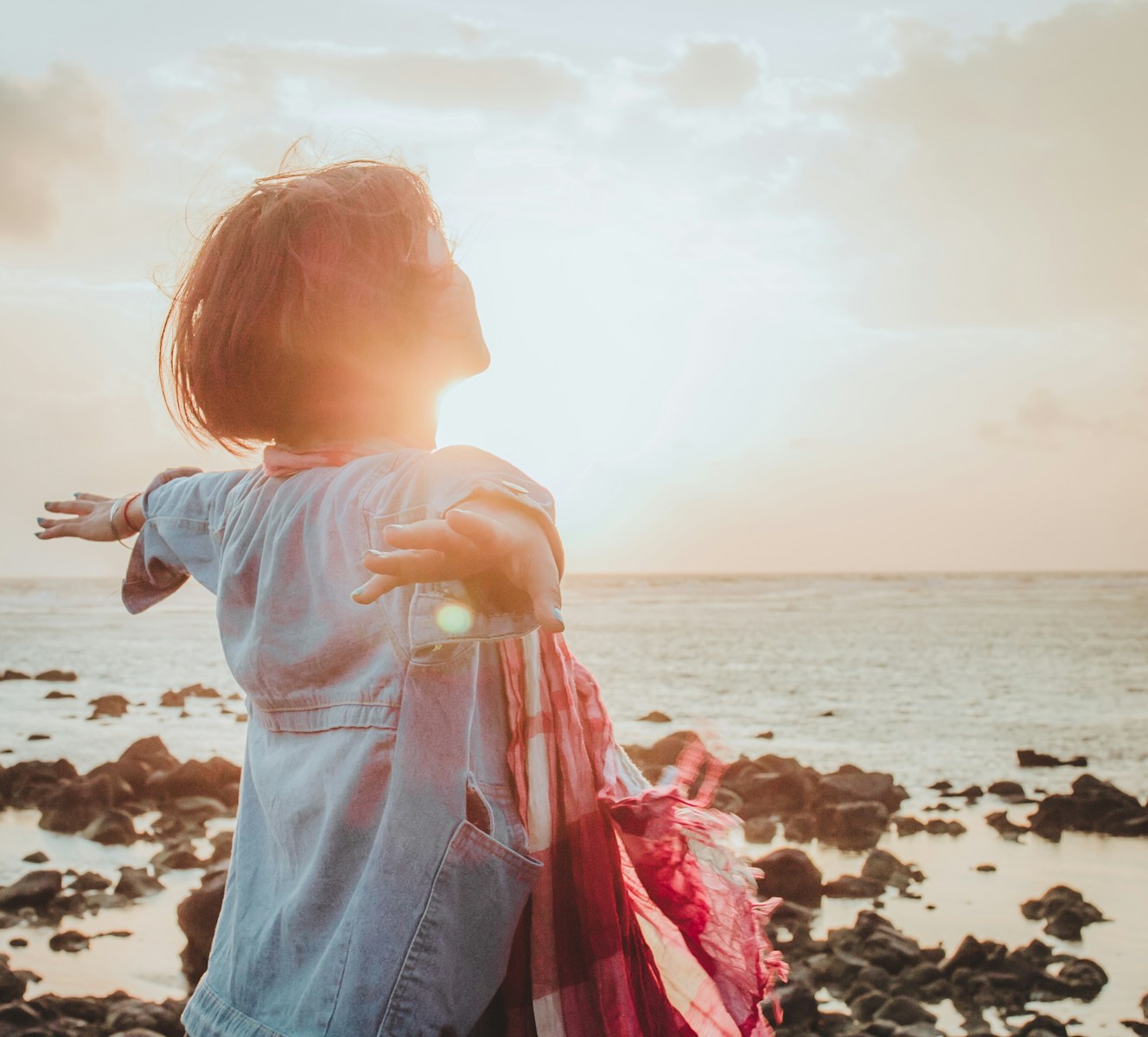 woman spreading her arms symbolizing freedom and adventure