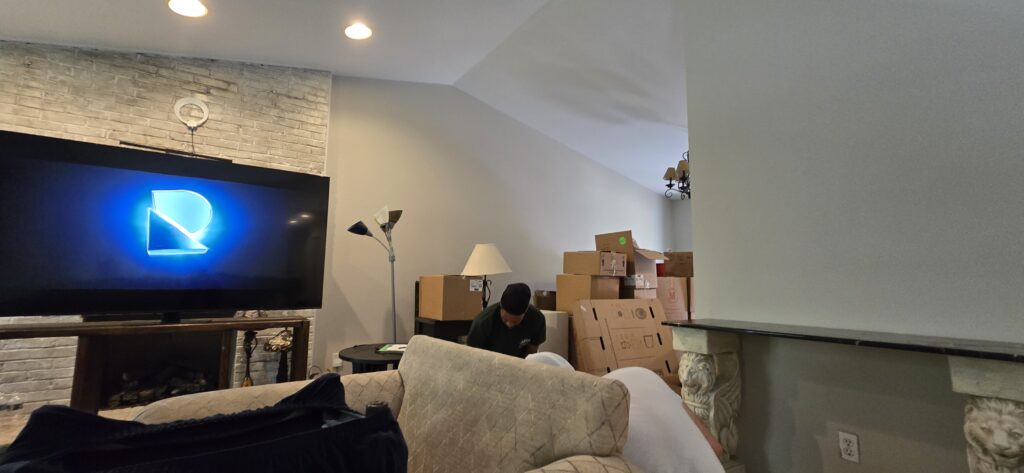 Partially unpacked moving boxes in a new home — embracing the messy reality and adventure of moving.