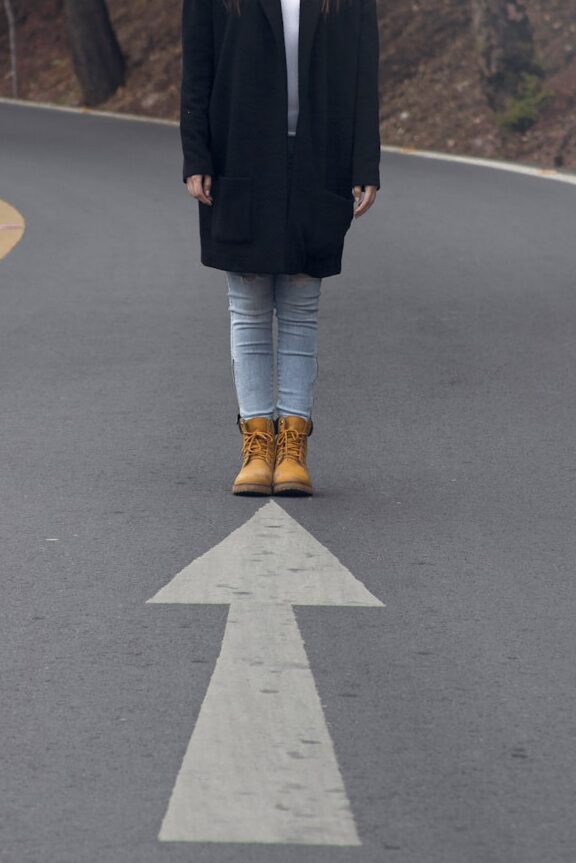 woman standing on asphalt road
