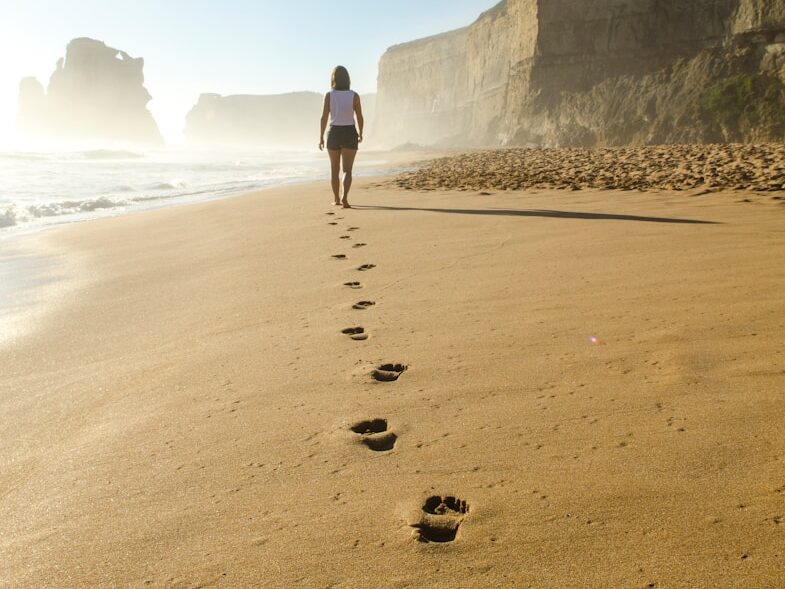 woman walking on shore
