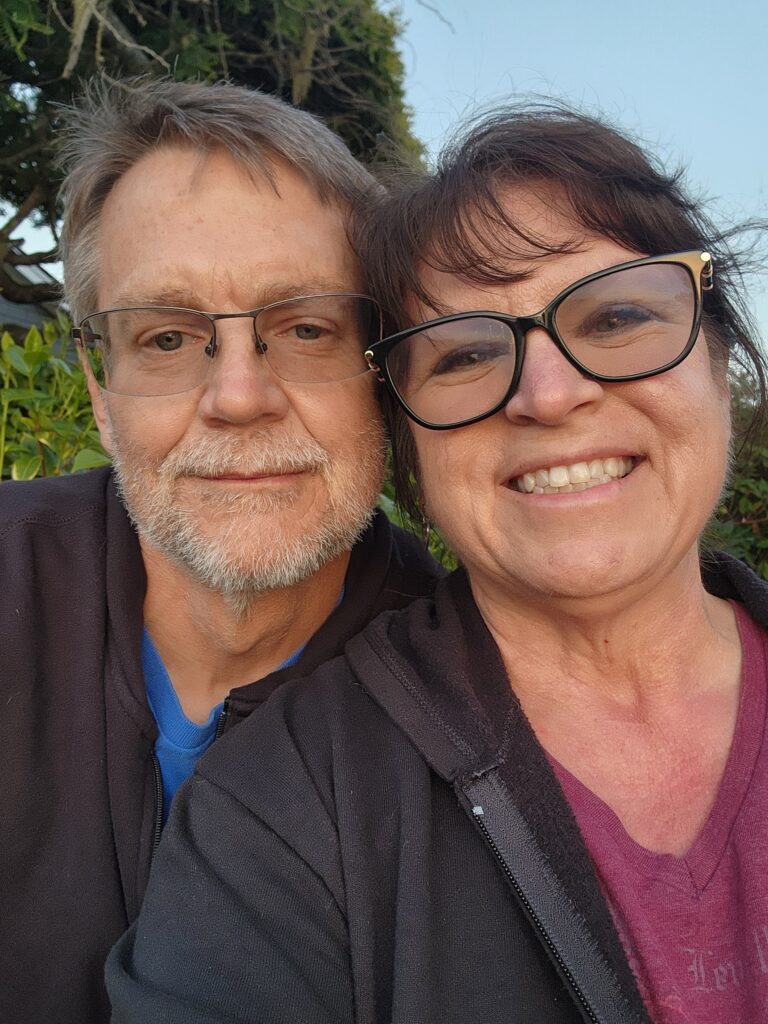 Couple smiling together outdoors at sunset—capturing the heart of slowing down and finding connection in everyday travel moments.