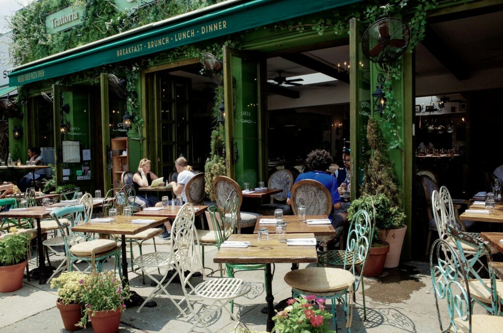 Street café table set with drinks, inviting travelers to slow down, connect, and soak in the local atmosphere.