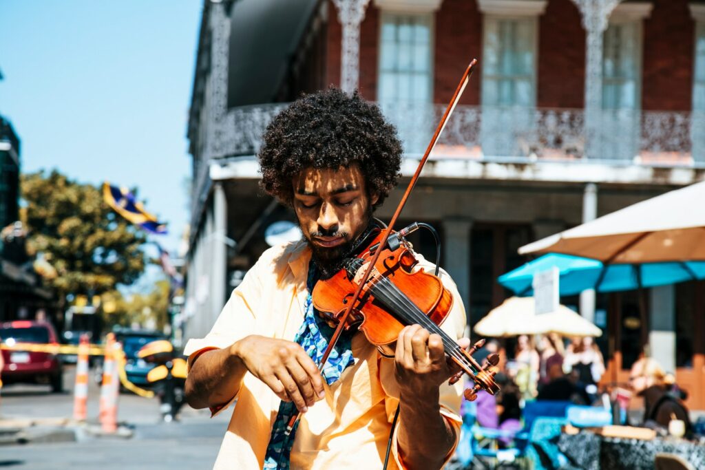 Street musician playing for passersby—capturing the spirit of connection and local life while traveling.
