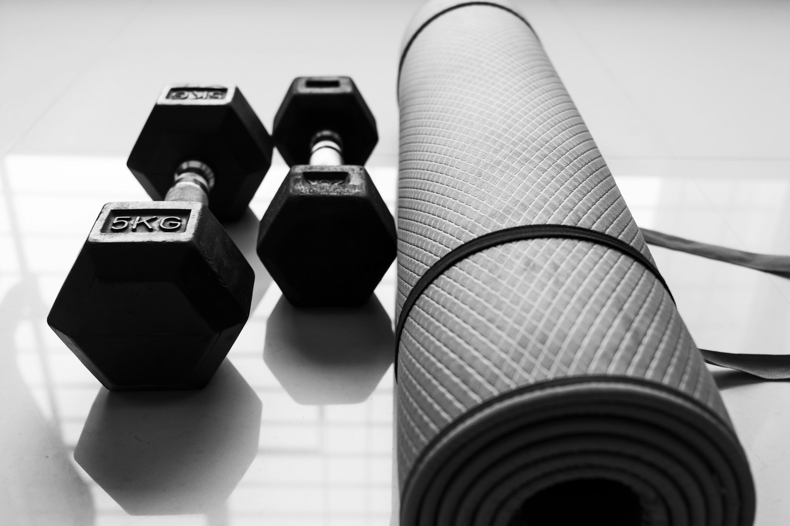 Home workout setup with dumbbells and yoga mat for strength training, mobility, and fitness over 50.