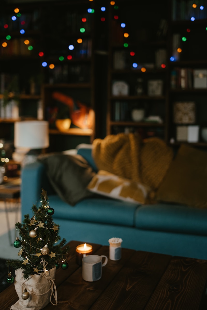 Cozy winter scene with warm lights, a mug, and a journal creating a calm holiday atmosphere.