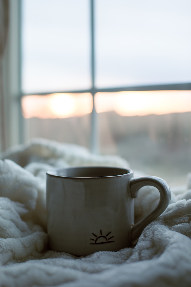 A quiet morning scene with soft window light and a warm drink, reflecting small grounding rituals and a fresh start.