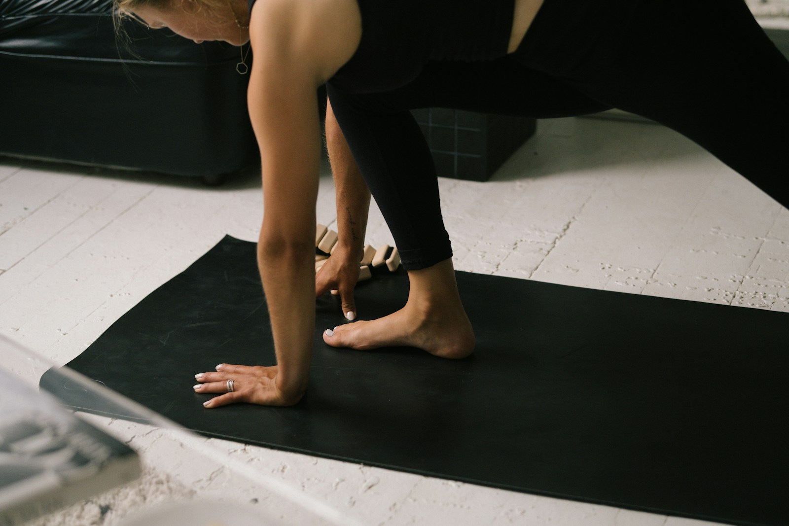Woman doing a simple home workout on a yoga mat to stay active during the holiday season
