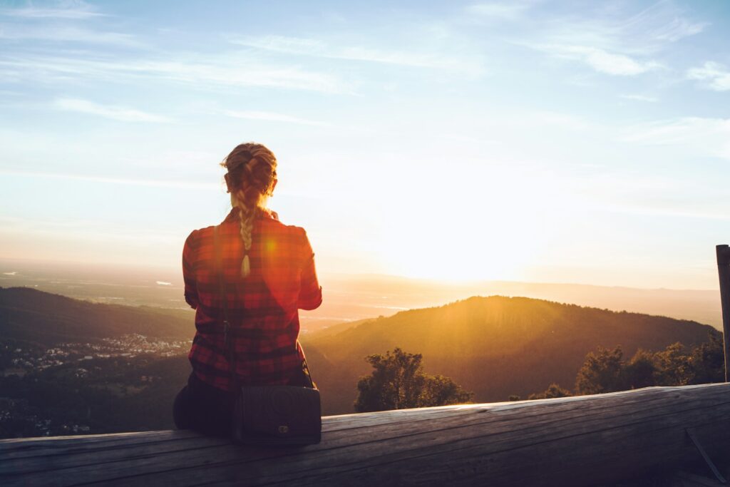 Person standing comfortably after movement outdoors, representing energy-first fitness and sustainable health.