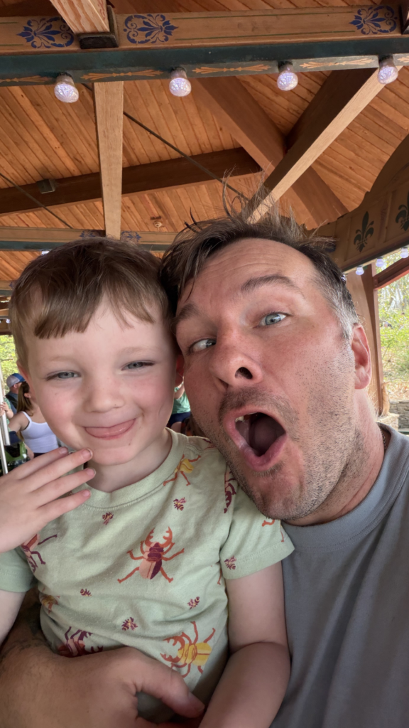 Son-in-law and grandson making silly faces together during a fun family moment