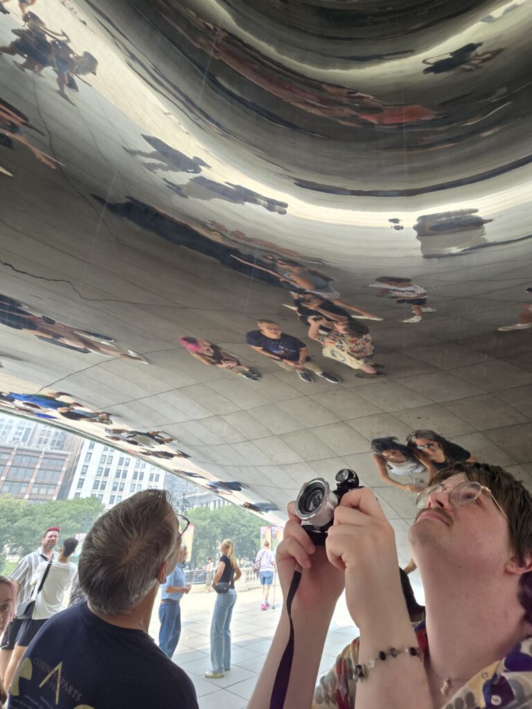 Andi and Tom standing beneath Cloud Gate (The Bean) in Millennium Park, Chicago.