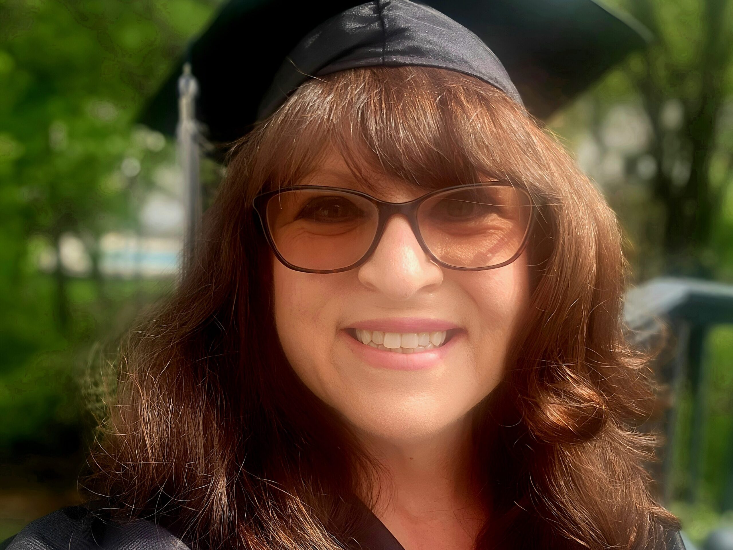 Graduation portrait representing a completed life transition and new professional chapter